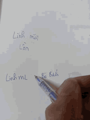 a person is writing on a piece of paper that says linh ma