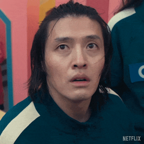 a man with long hair is wearing a green netflix uniform