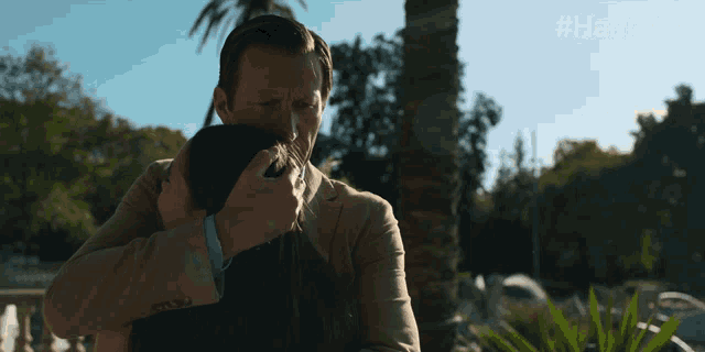 a man holds a woman in his arms with the hashtag #hannatv