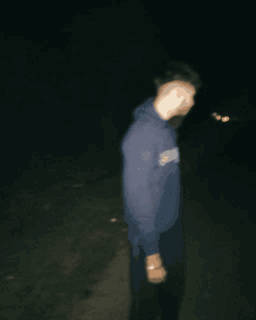 a blurry picture of a man wearing a hoodie that says ' abercrombie ' on it