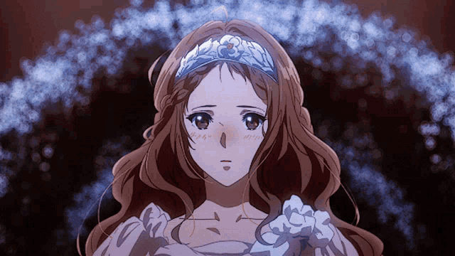 a girl with a tiara on her head looks at the camera