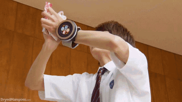 a man in a white shirt and tie is wearing a watch that says dryedmangoez.com on it