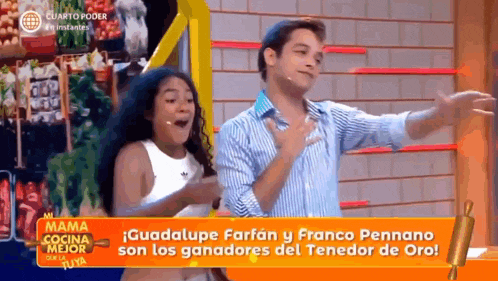 a man and a woman are dancing in front of a mama cocina mejor sign