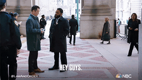 two men standing on a sidewalk with the words hey guys written on the ground
