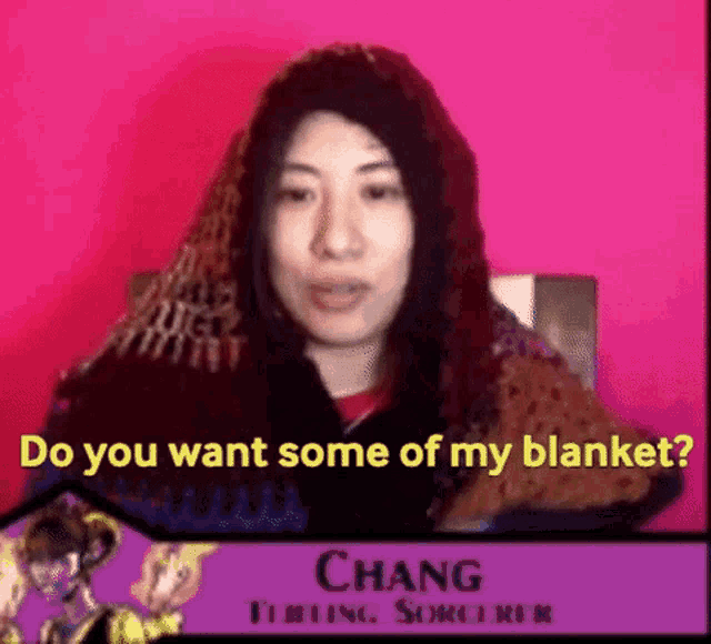 a woman wearing a scarf and a red shirt says do you want some of my blanket