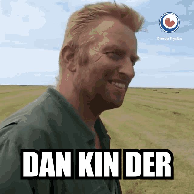 a man standing in a field with the words dan kin der on the bottom