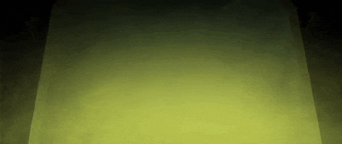 a dark room with a yellow light coming out of it