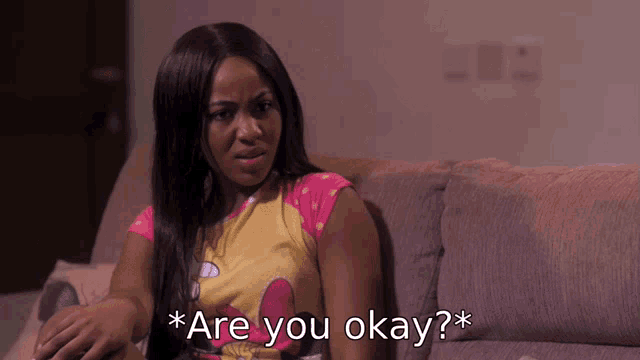 a woman sitting on a couch with the words " are you okay " on the bottom