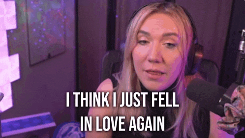 a woman wearing headphones is talking into a microphone and saying i think i just fell in love again .