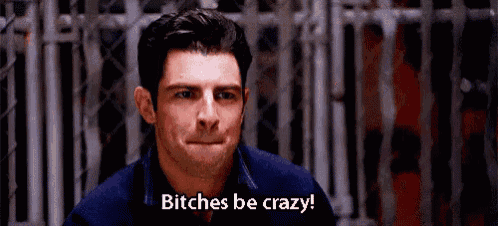 a man is making a face and saying `` bitches be crazy '' in front of a chain link fence .