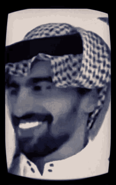 a black and white drawing of a man wearing a turban and smiling