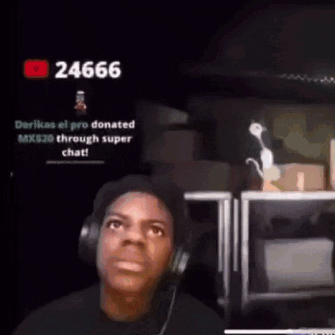 a man wearing headphones is looking at the camera while playing a video game .