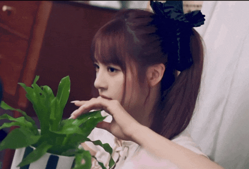 a girl with red hair and a black bow on her head