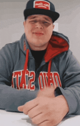 a man wearing a hat and a hoodie that says ohio on it