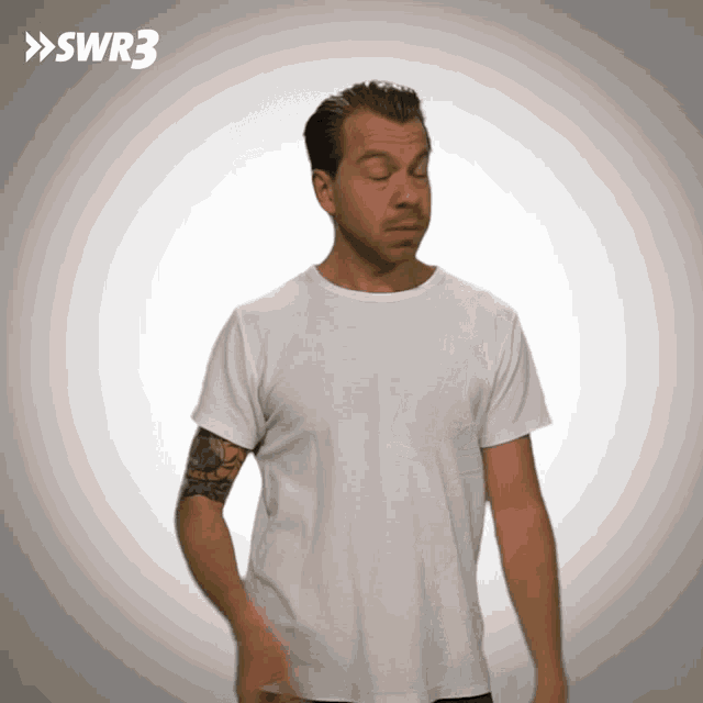 a man with a tattoo on his arm is wearing a white t-shirt with swr3 on the bottom