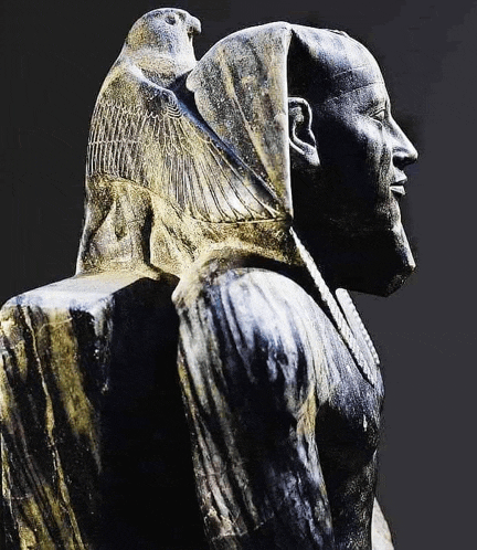 a statue of a man with a bird on his shoulders .