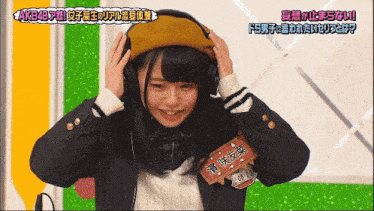 a girl wearing headphones with a name tag that says akb48