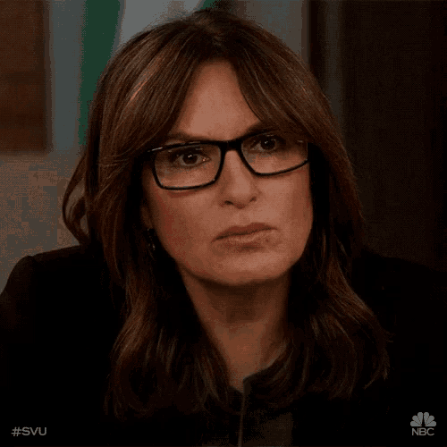 a close up of a woman wearing glasses with the hashtag #svu on the bottom right