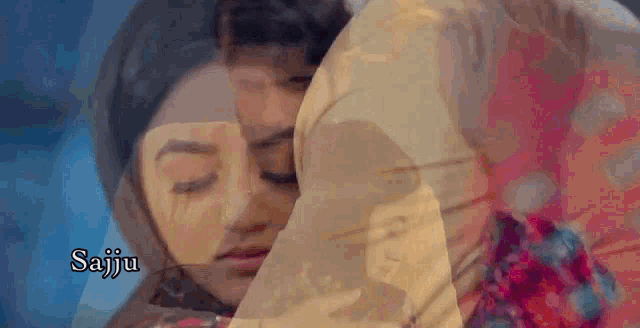a man and a woman are hugging each other in a room .