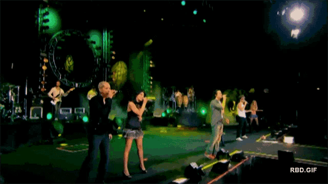 a group of people singing on a stage with the url rbd.gif