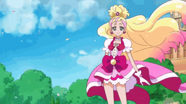 a girl in a pink and white dress stands in front of a castle
