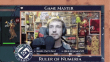 a man wearing headphones is sitting in front of a screen that says game master ruler of numberia