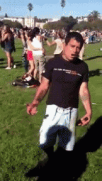 a man in a black shirt is standing in a field