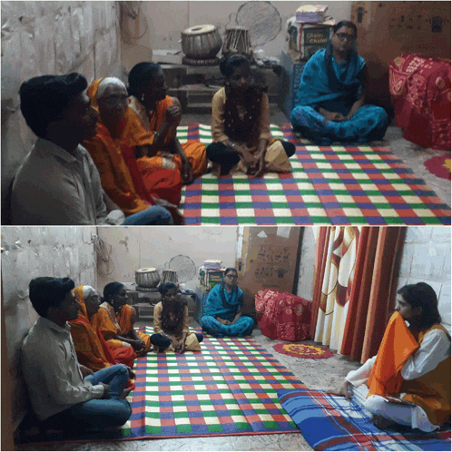 a group of people are sitting on a checkered mat in a room