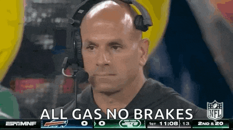 a man wearing a headset says " all gas no brakes " during a football game