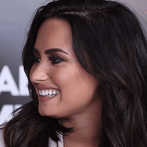 a close up of a woman 's face with the letter a visible in the background