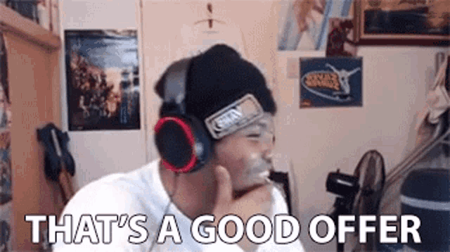 a man wearing headphones and a beanie says `` that 's a good offer '' in a room .