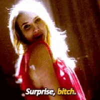 a woman in a red dress is saying surprise , bitch .