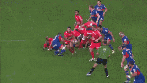 a group of rugby players are playing on a field and one of them has the number 2 on his jersey