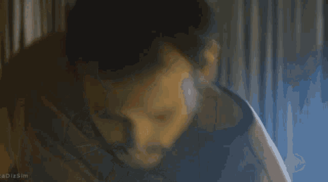 a man and woman are hugging each other in a room with candles .