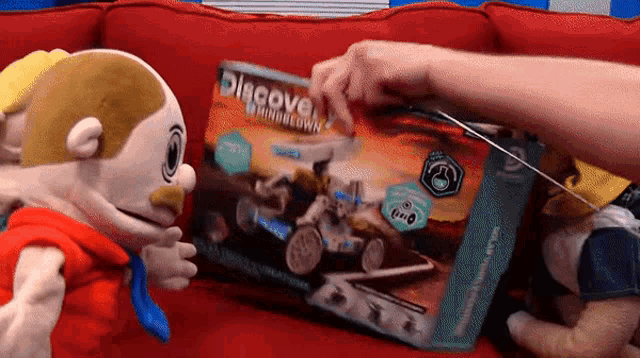 a person is playing with a toy that says discover