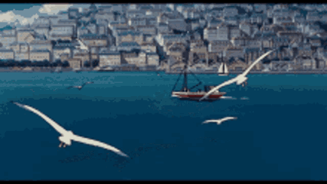 several birds are flying over a body of water with a boat in the background