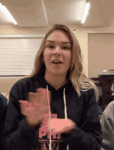 a girl wearing a black sweatshirt with the word pitt on it