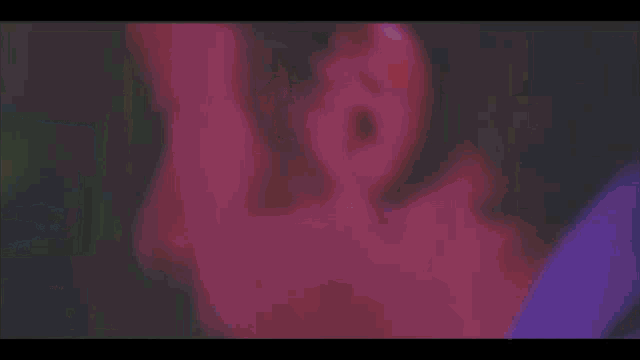 a pixelated image of a man 's face with a purple light behind him