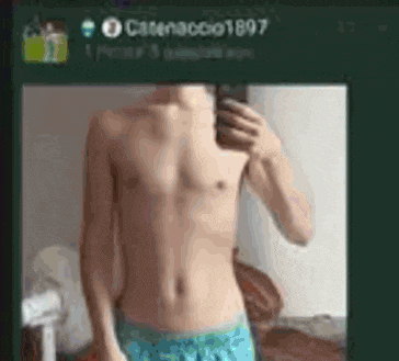 a shirtless man is taking a selfie with his phone