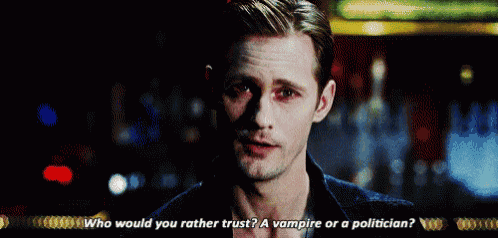 a close up of a man 's face with the words who would you rather trust a vampire or a politician