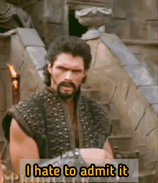 a man with a beard says " i hate to admit it " while standing in front of stairs