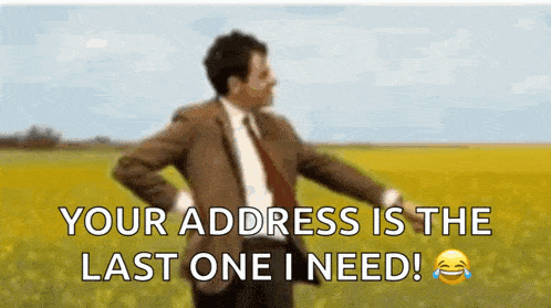 mr bean is standing in a field with his hands on his hips .