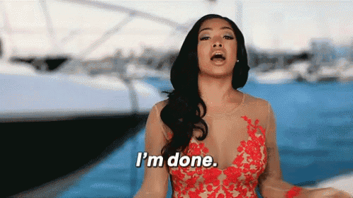 a woman in a red dress is standing in front of a boat and says i 'm done .