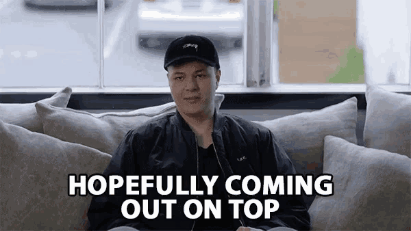 a man sitting on a couch with the words hopefully coming out on top