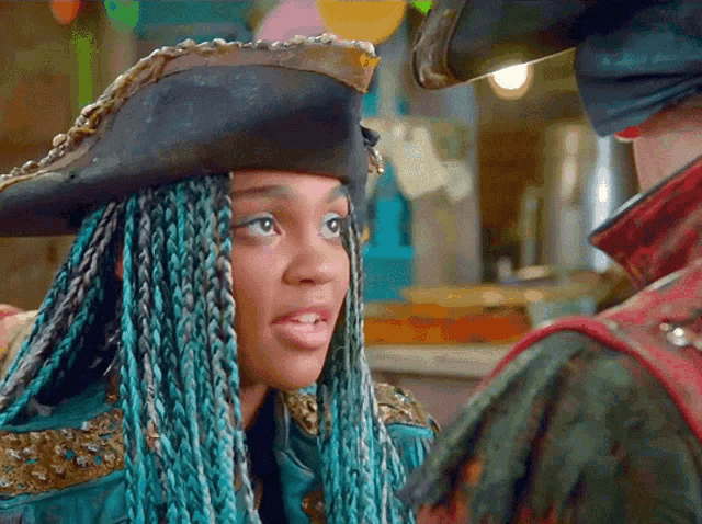 a woman with blue braids and a pirate hat