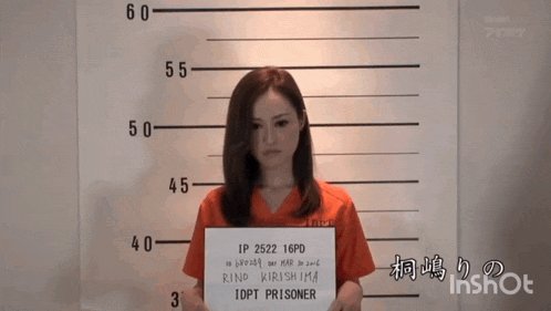 a woman in a jail uniform is holding up a sign that says rind kirishima