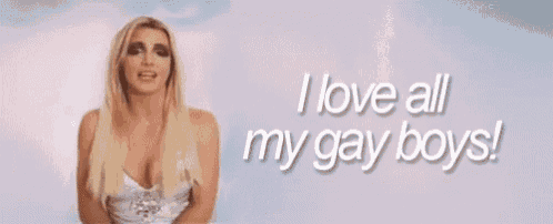 a blonde woman is standing in front of a sign that says i love all my gay boys .