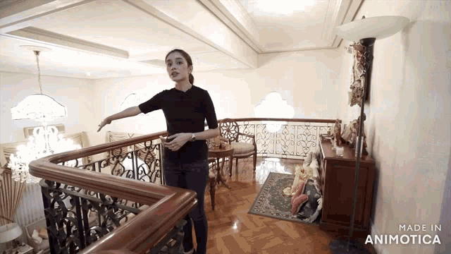 a woman standing on a staircase with the words made in animotica on the bottom right