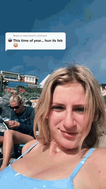 a woman in a blue bikini has a reply to a comment that says this time of year ... hun its feb