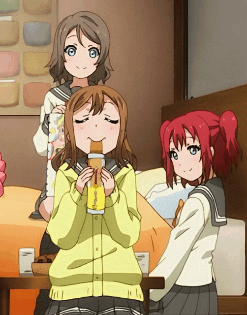 a girl in a yellow jacket is eating a sandwich while another girl looks on